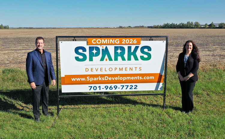 Lee and Nancy Sparks with development sign | Sparks Developments